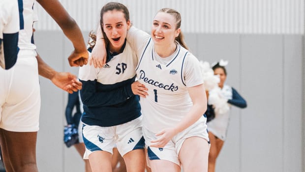 Rachel Kuhl and Lara Aguzzi celebrate Saint Peter’s women’s basketballs first win in more than 600 days.